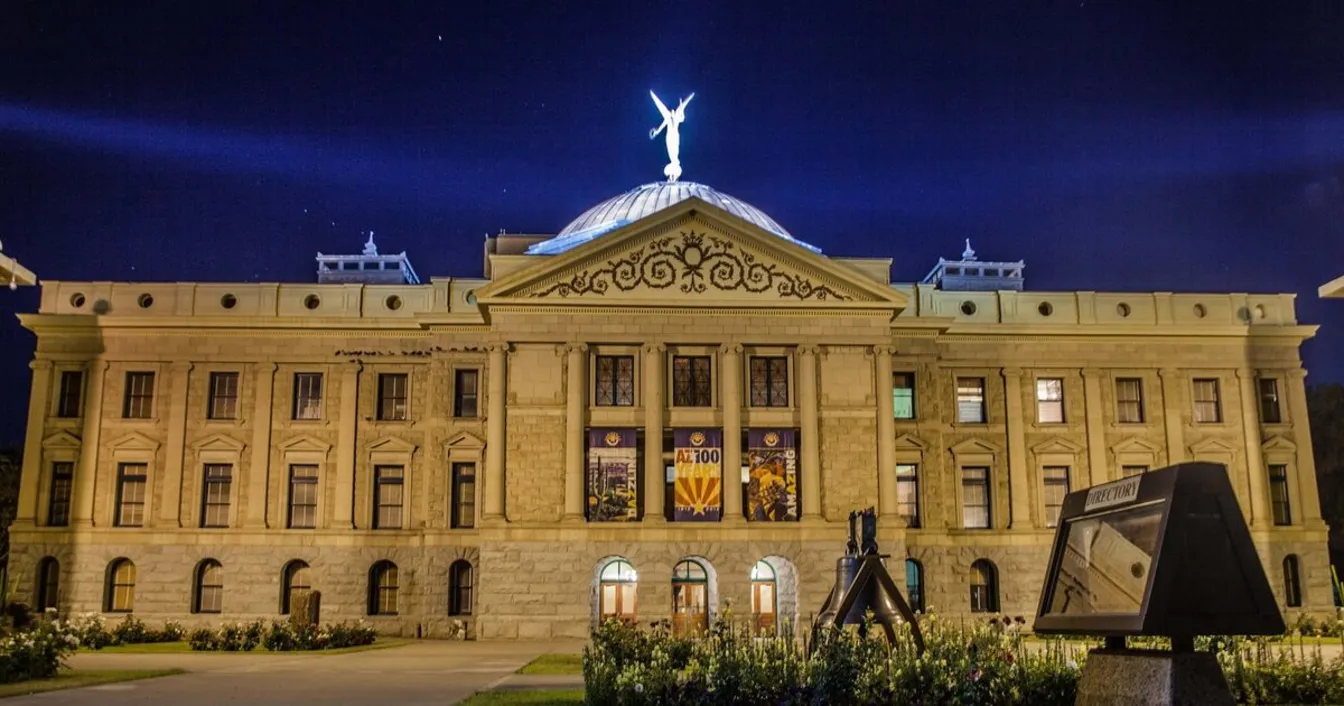 The historic Arizona State Capitol building illuminated at night in Phoenix, where SB 1507 was passed into law